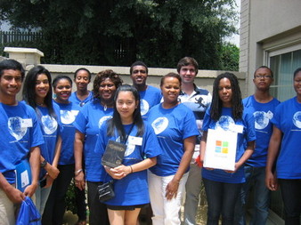 group of adults and youth wearing blue shirts for their organization